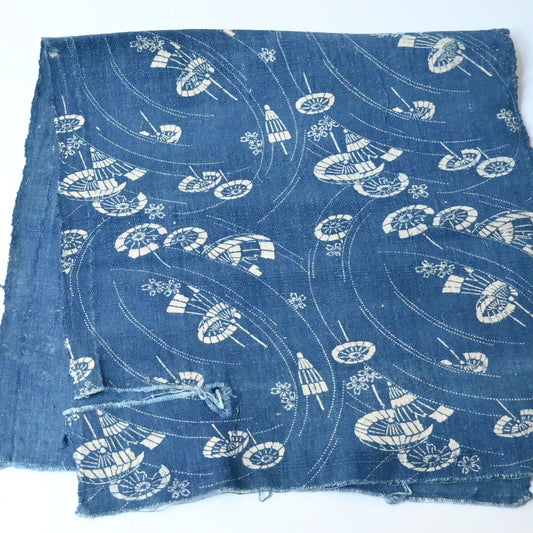 Full view of antique indigo katazome cotton with flowing wagasa (Japanese paper umbrellas) and cherry blossom motifs.