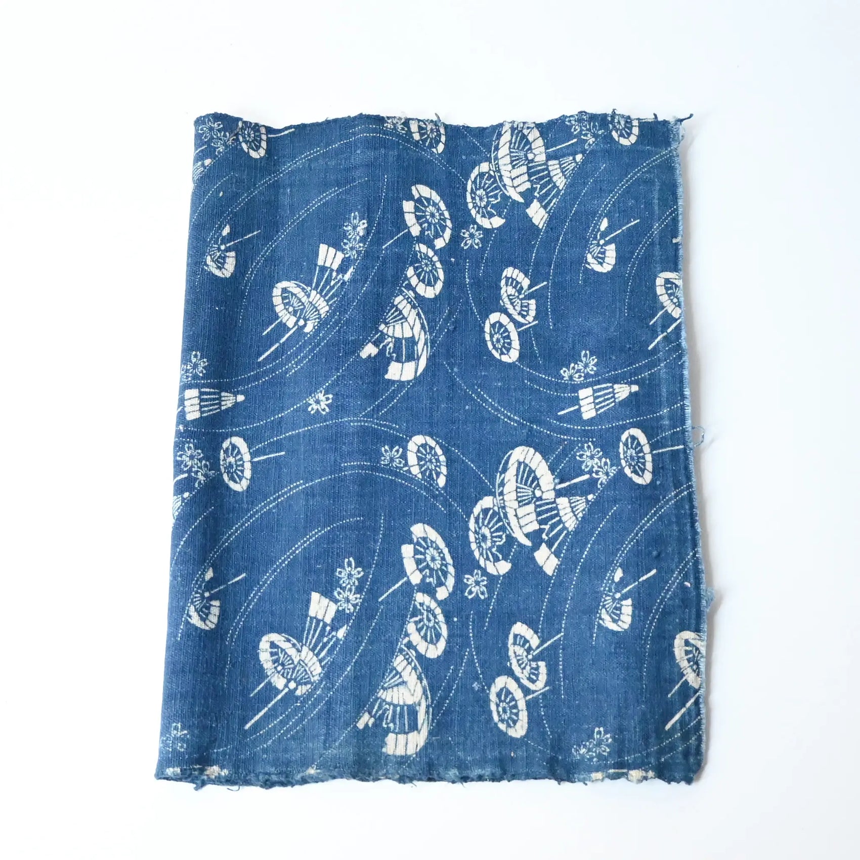 Antique indigo katazome cotton with flowing wagasa (Japanese paper umbrellas) and cherry blossom motifs.
