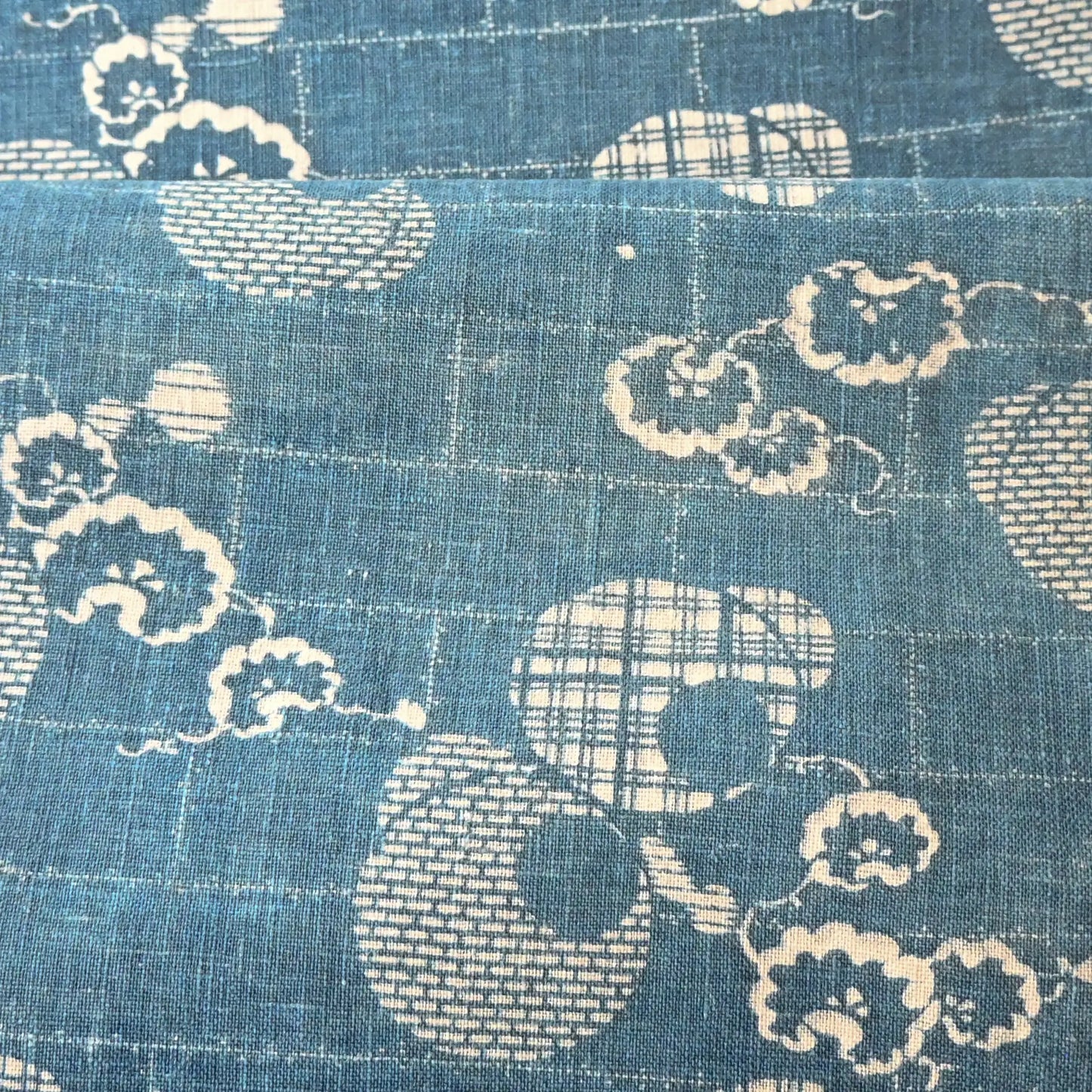 Detailed view of rare antique indigo Katazome stencil died cotton with a delicate snowflake motif.