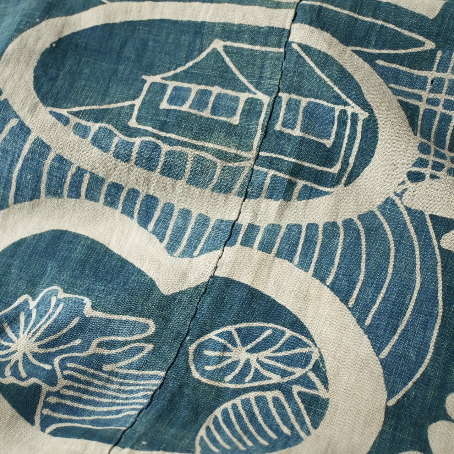 Close-up view of rare antique indigo tsutsugaki-dyed cotton futon cover with tea ceremony utensils motif.