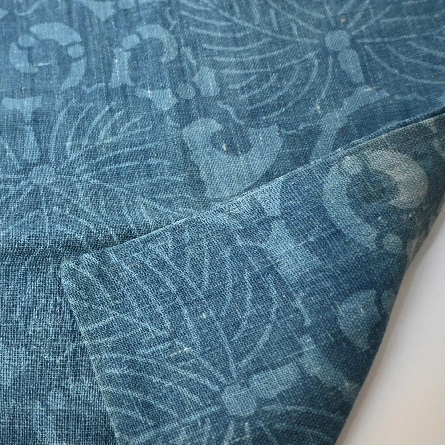 Detailed view of antique Japanese indigo katazome dyed cotton with paulownia arabesque pattern from the early 20th century.