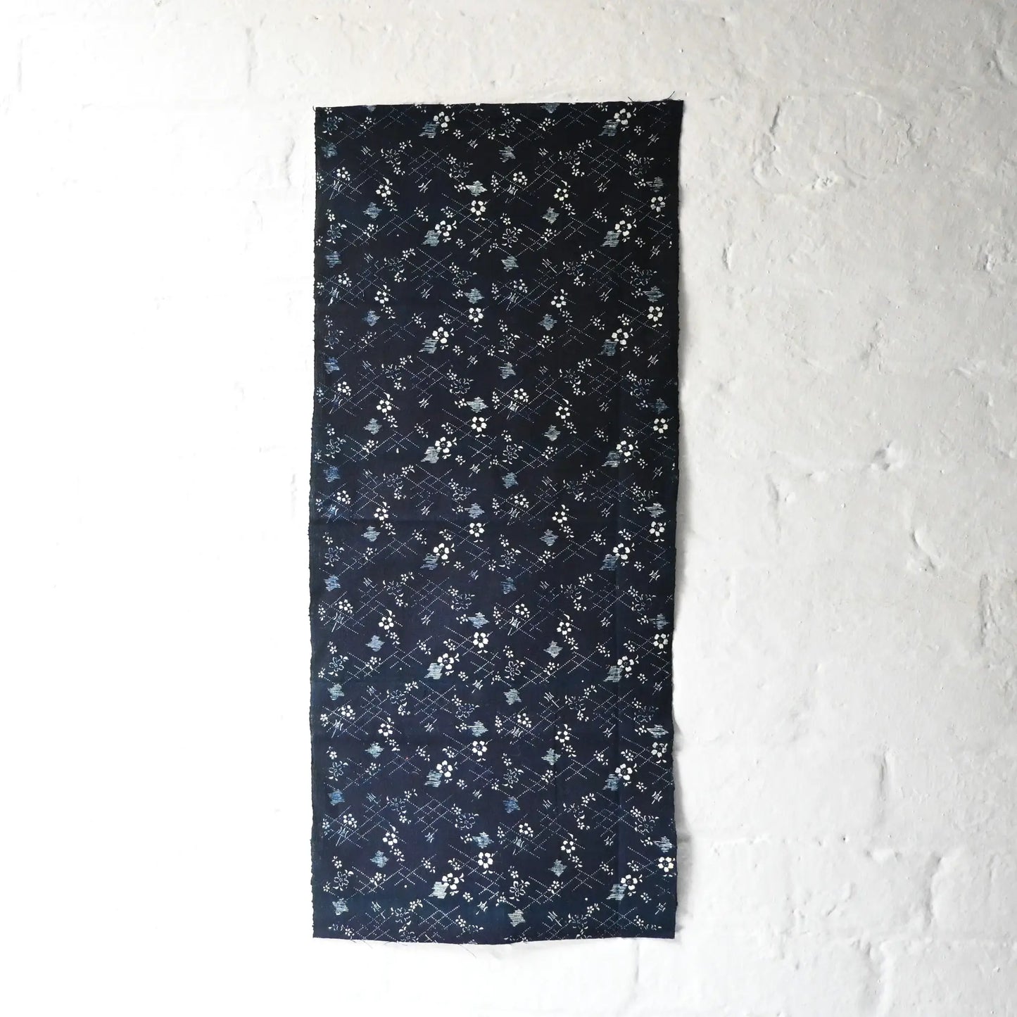 Full view of antique Japanese indigo Katazome cotton with intricate dots, lines and cherry blossoms from the early 20th century.