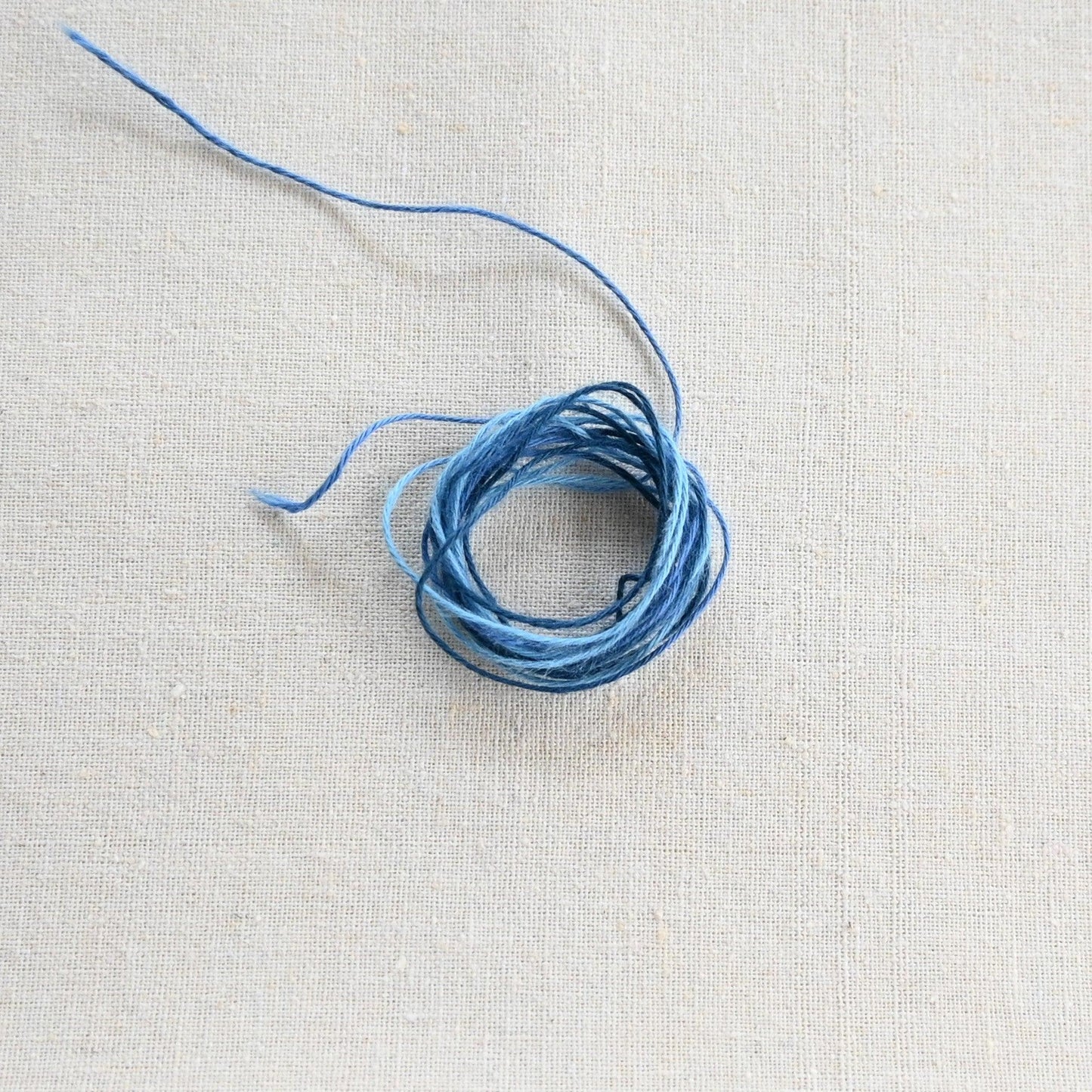 Authentic Japanese Hida sashiko threads in blue gradation on calico cotton.