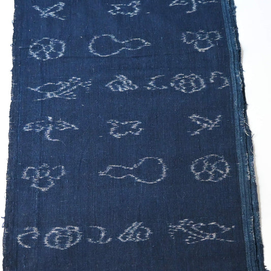 Rare vintage indigo kasuri cotton with pictorial motifs, including gourds, plum blossoms, and umbrellas.