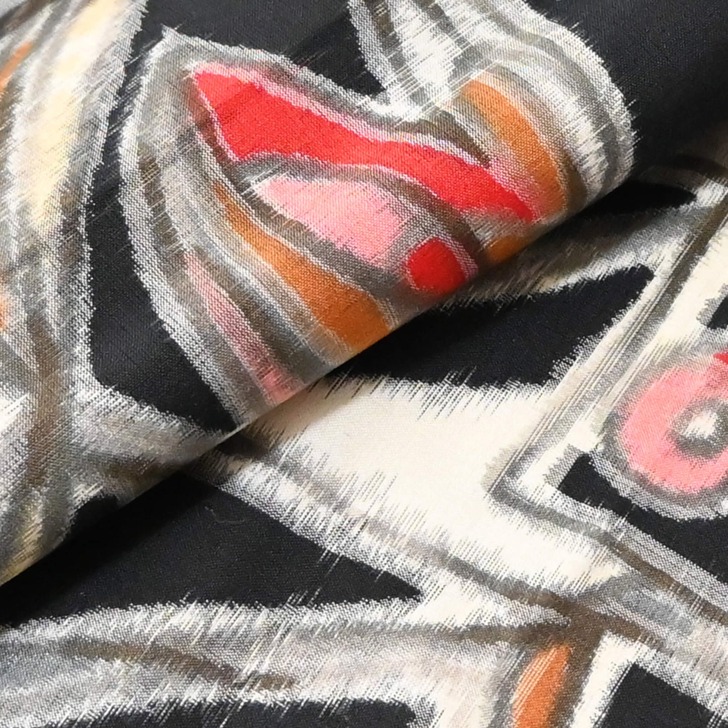 Close up view of vintage Meisen kimono silk fabric with blurry patterns.