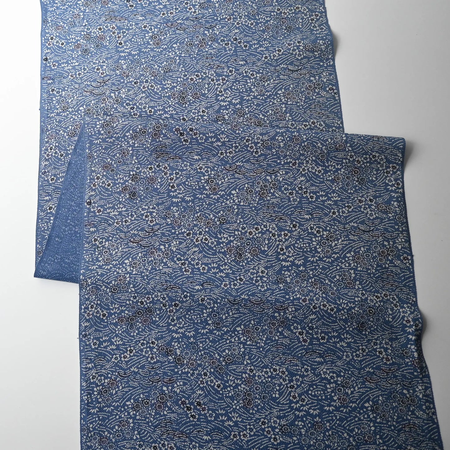 Full view of vintage blue heavy silk crepe kimono fabric with katazome dyed small floral pattern.