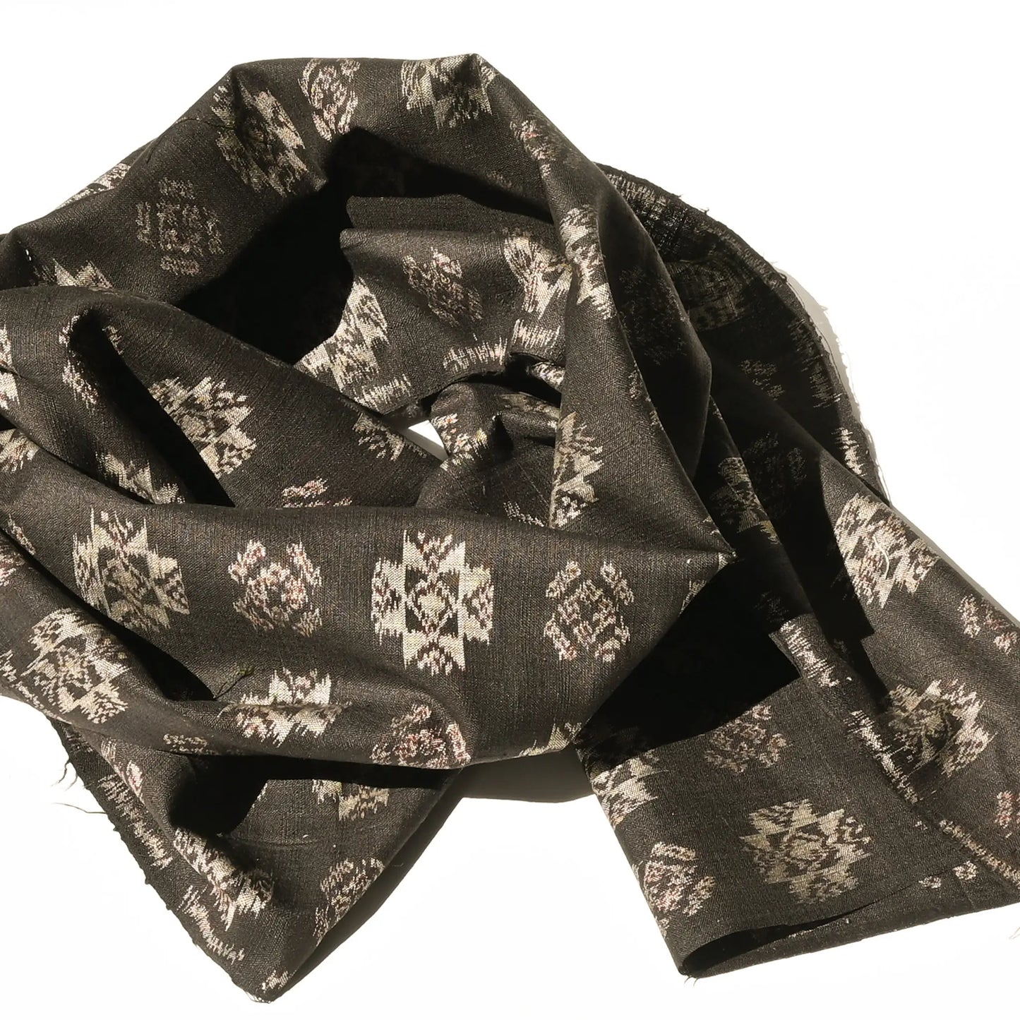 Detailed view of vintage Japanese silk kimono fabric in rich dark brown with kasuri woven pattern.