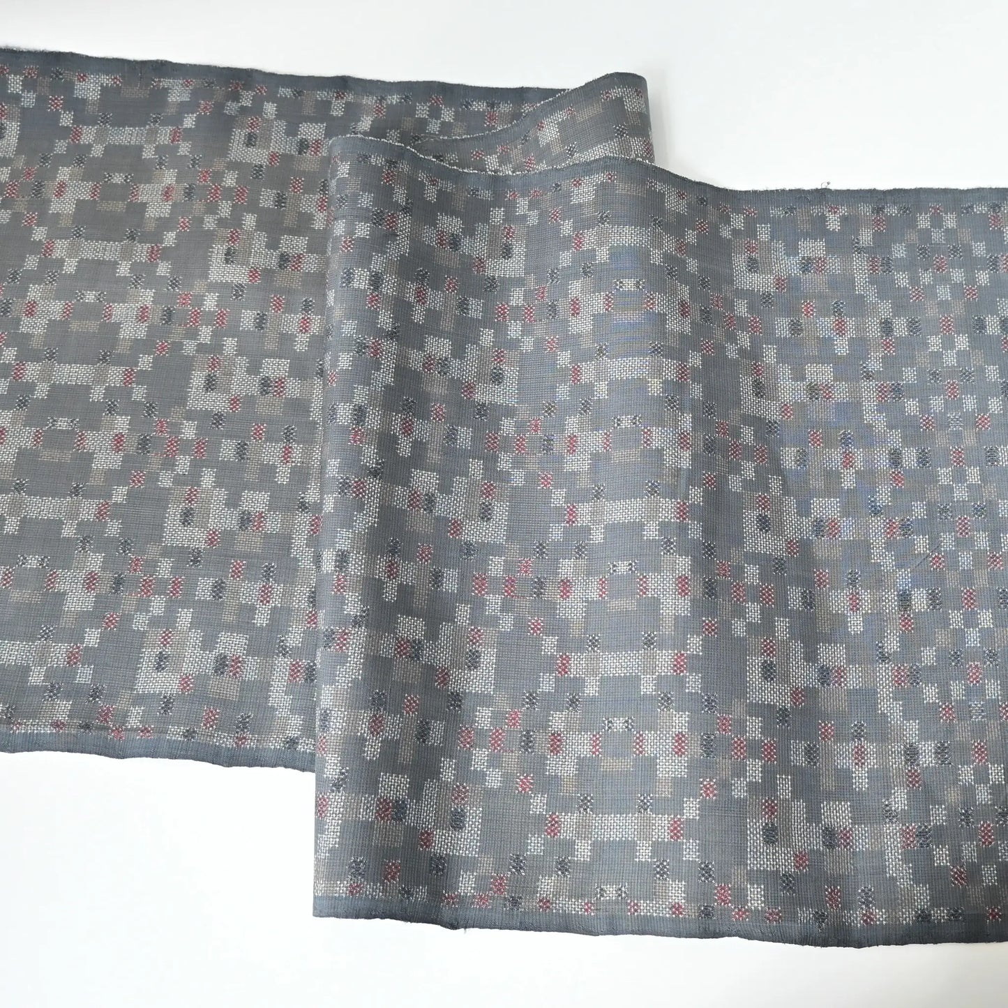 Full view of vintage silk kimono fabric in green grey with a charming check pattern.