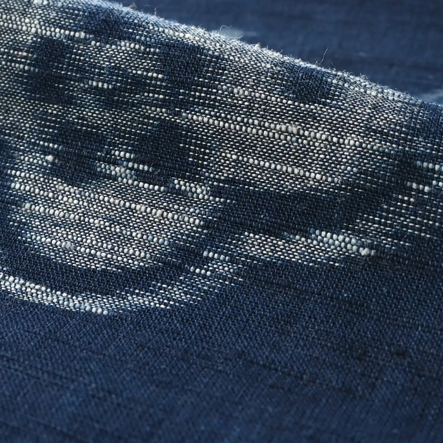 Close-up view of vintage Japanese indigo egasuri cotton, pine tree motif with a beautiful texture.