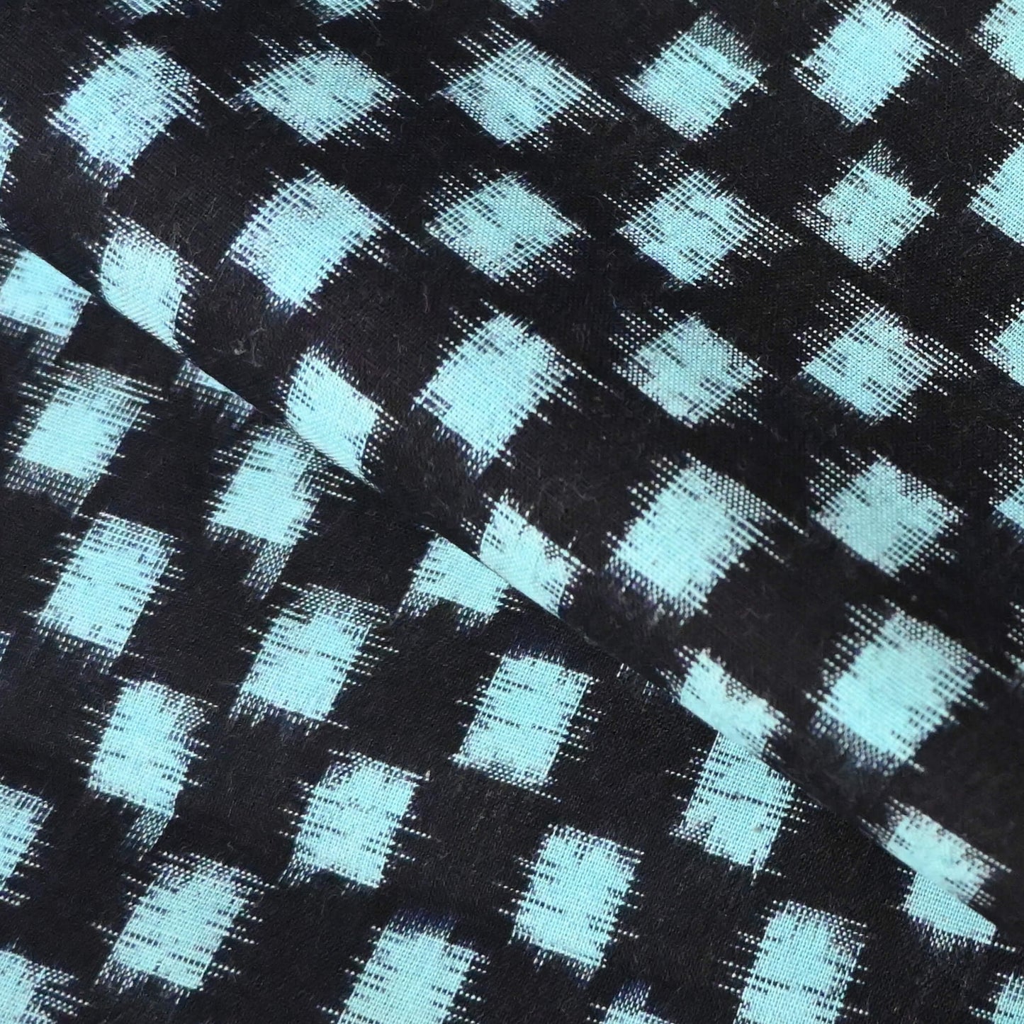Close-up view of vintage Japanese indigo classic kasuri check cotton sold by the metre.
