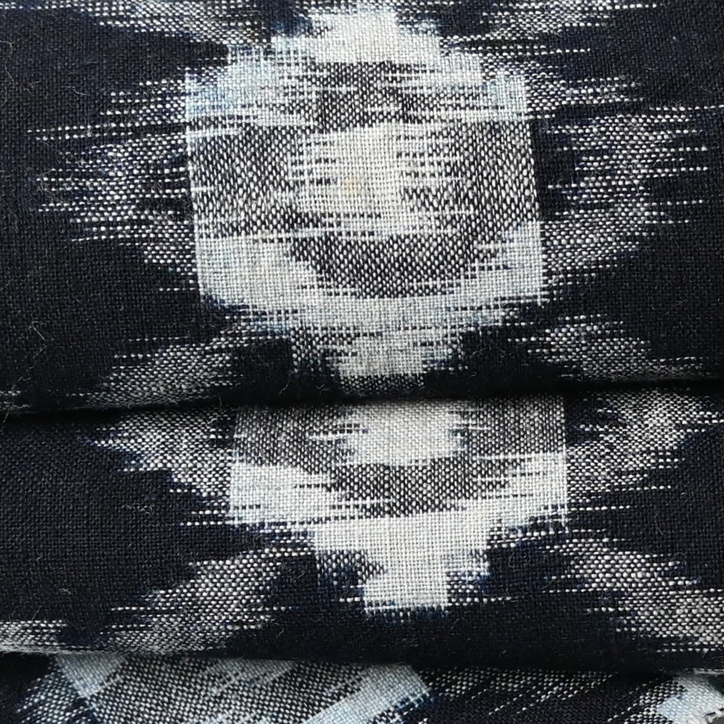 Close up view of vintage Japanese indigo Kasuri cotton kimono piece, ikat woven pattern.