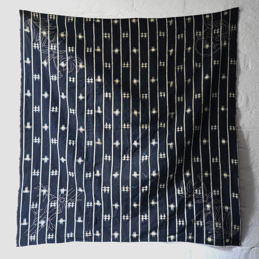 Full view of vintage three-panel indigo kasuri cotton furoshiki with hand stitched botanical motifs on the corner.