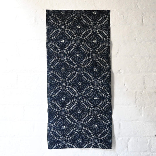 Full view of vintage indigo katazome cotton piece with Shippo-tsunagi with stylised chrysanthemum motif.