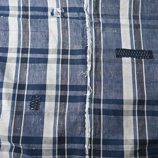 Close-up of vintage Japanese indigo plaid cotton futon cover with some small mended patches.