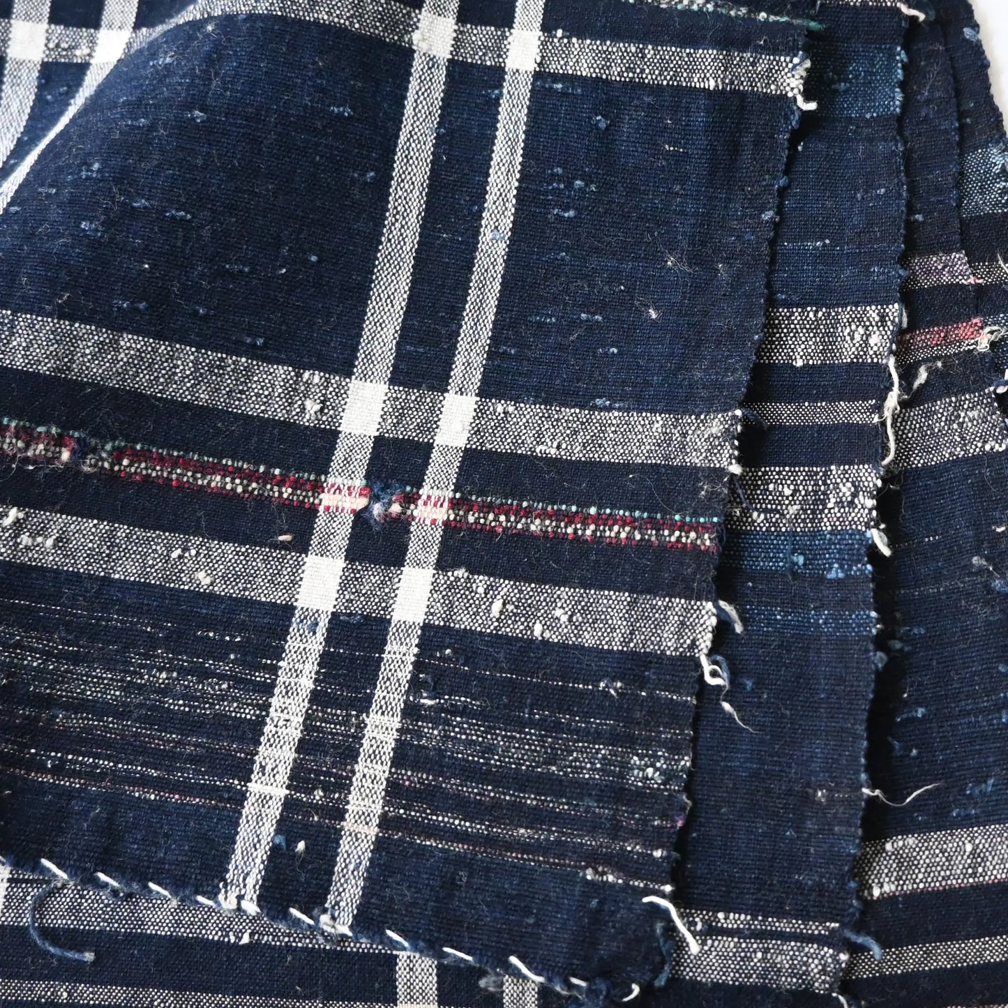 Close-up view of vintage Japanese indigo zanshi ori cotton with check pattern.