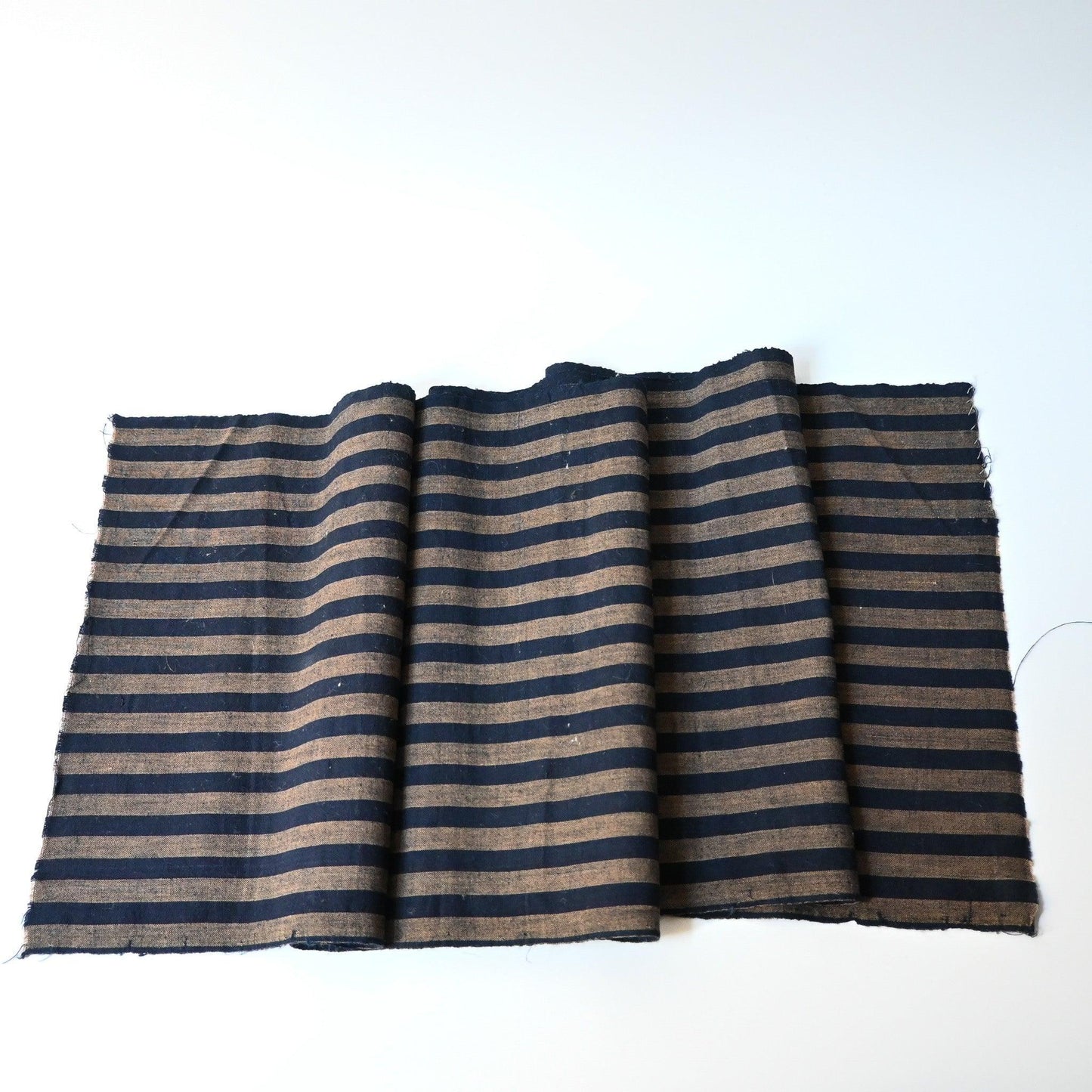 Full view of vintage Japanese indigo and brown stripe cotton fabric.