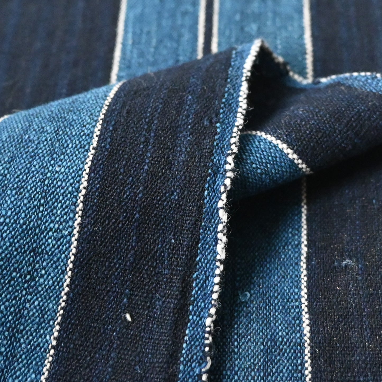 Detailed view of vintage Japanese heavy weight indigo cotton with a bold stripe pattern.