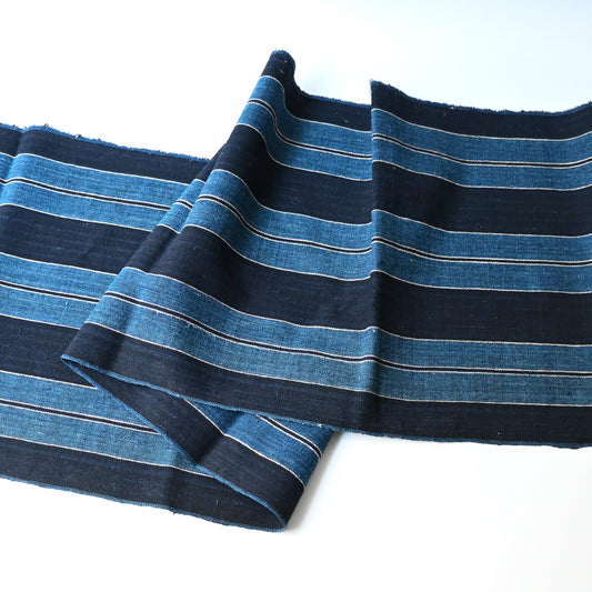 Full view of vintage Japanese heavy weight indigo cotton with a bold stripe pattern.