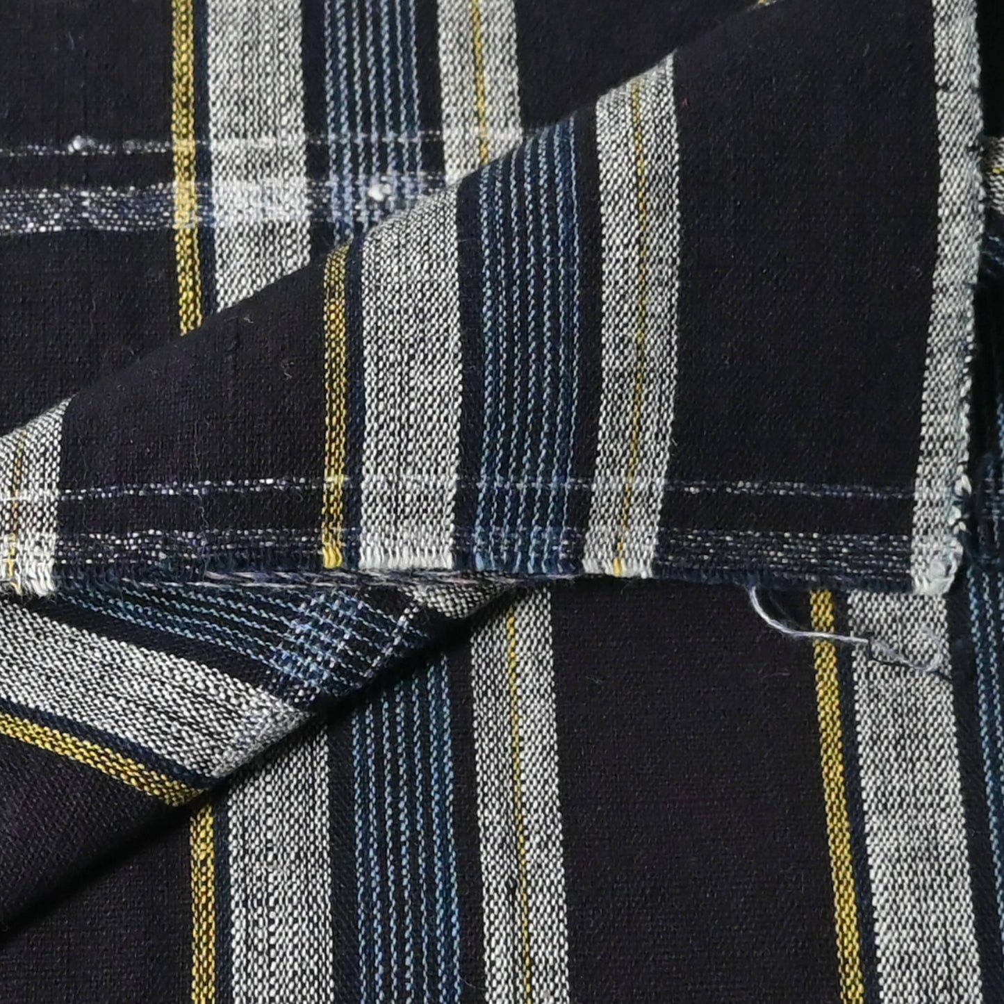 Close-up view of vintage Japanese indigo check cotton fabric piece.
