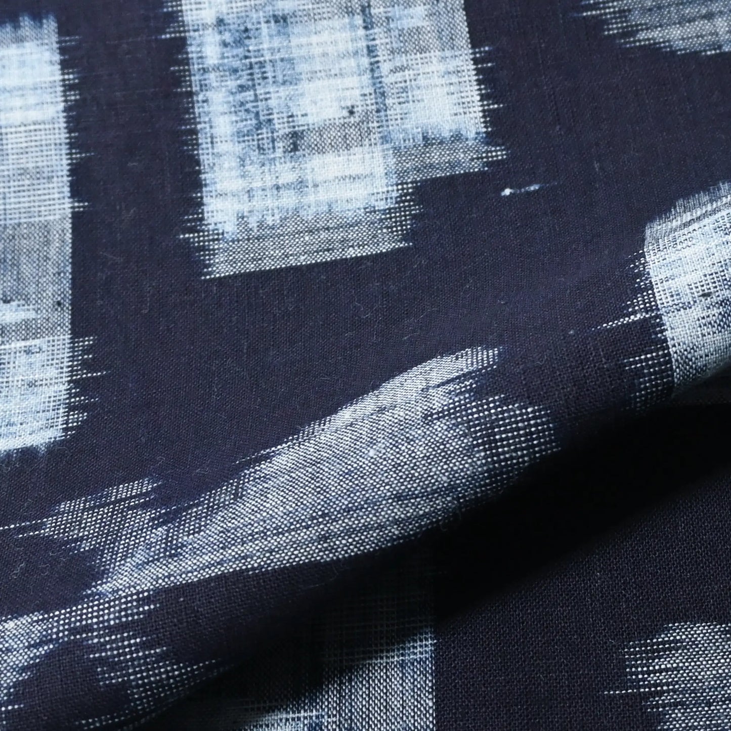 Detailed view of vintage Japanese indigo kasuri cotton kimono piece with a bold motif.