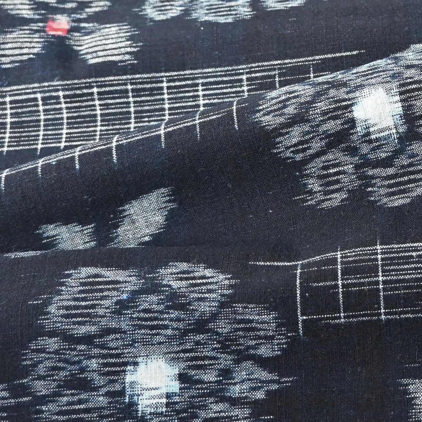 Detailed view of vintage indigo Kurume-gasuri cotton with floral pattern from mid 20th century.