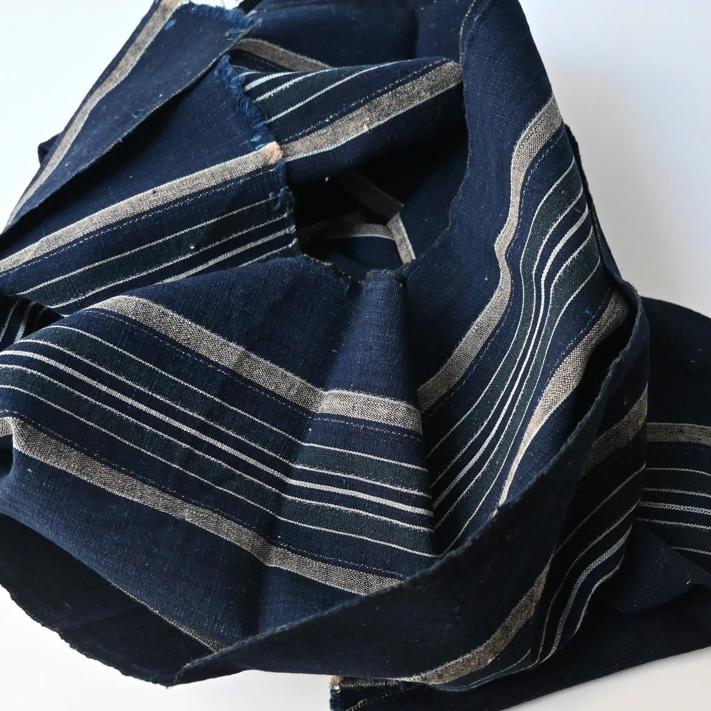 Close-up view of vintage Japanese indigo futon cover panel, stripe with green and beige.
