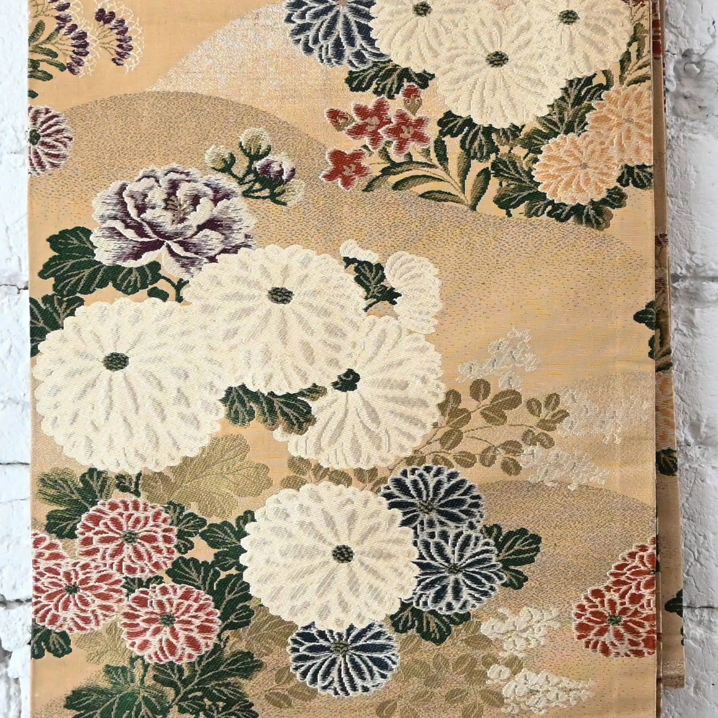 Detailed view of vintage Japanese women's silk brocade Maru obi with chrysanthemum motif.
