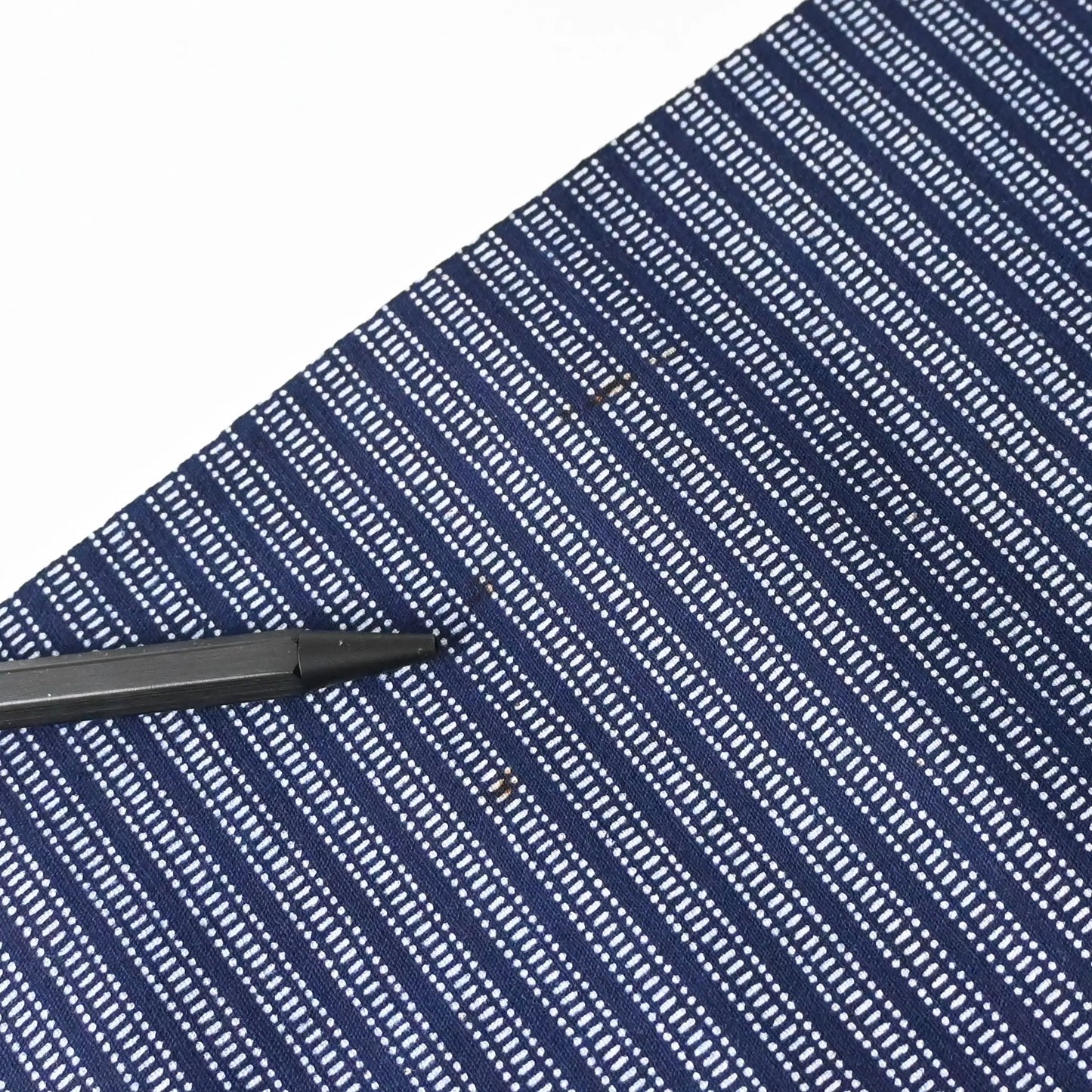 Detailed shot of age spots, vintage Japanese geometric yukata cotton fabric sold by the metre.