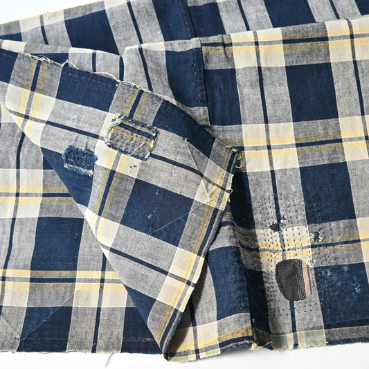 Vintage Japanese indigo and soft yellow check cotton futon cover panel with mended patches.