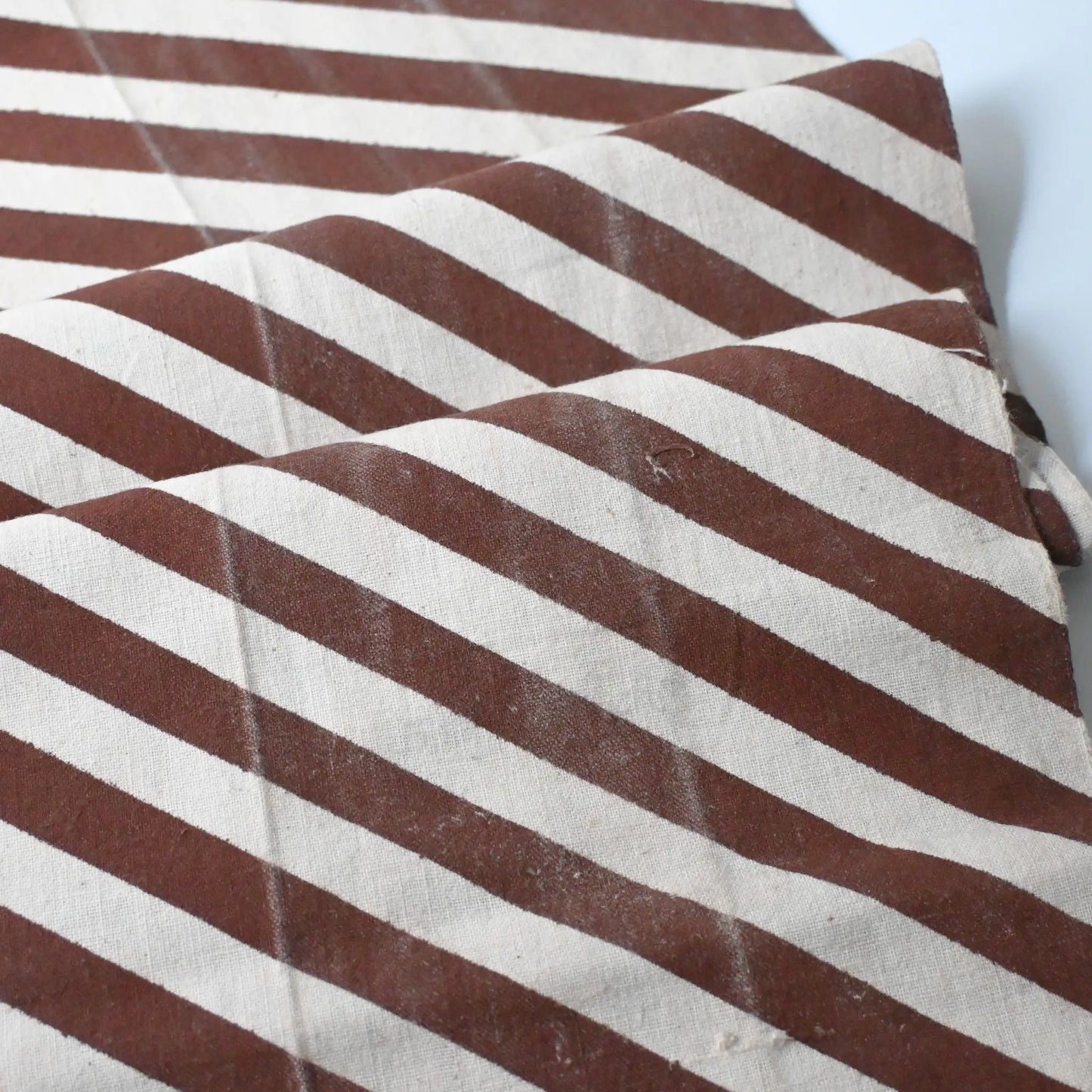 Detailed view of vintage Japanese white and brown diagonal stripe cotton.