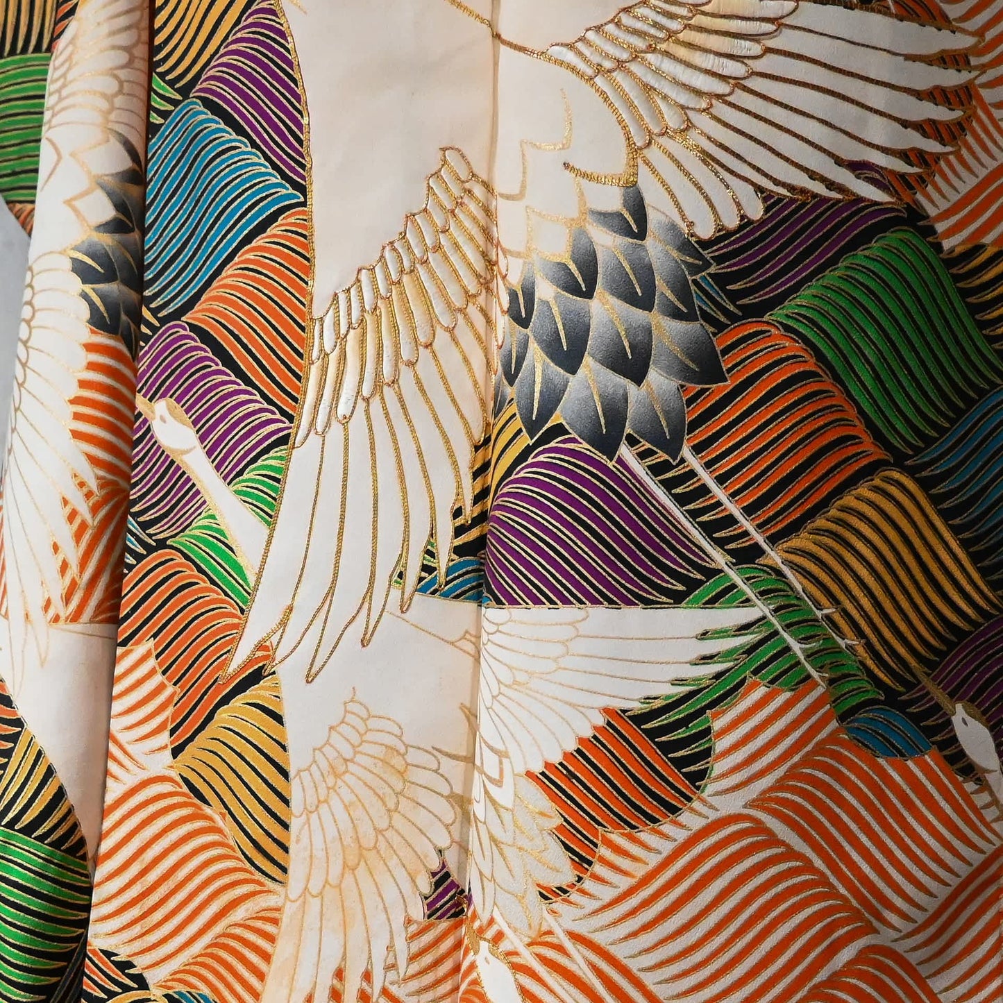 Detailed view of vintage Japanese women's long-sleeved formal kimono Furisode with crane and wave, mildly stained.