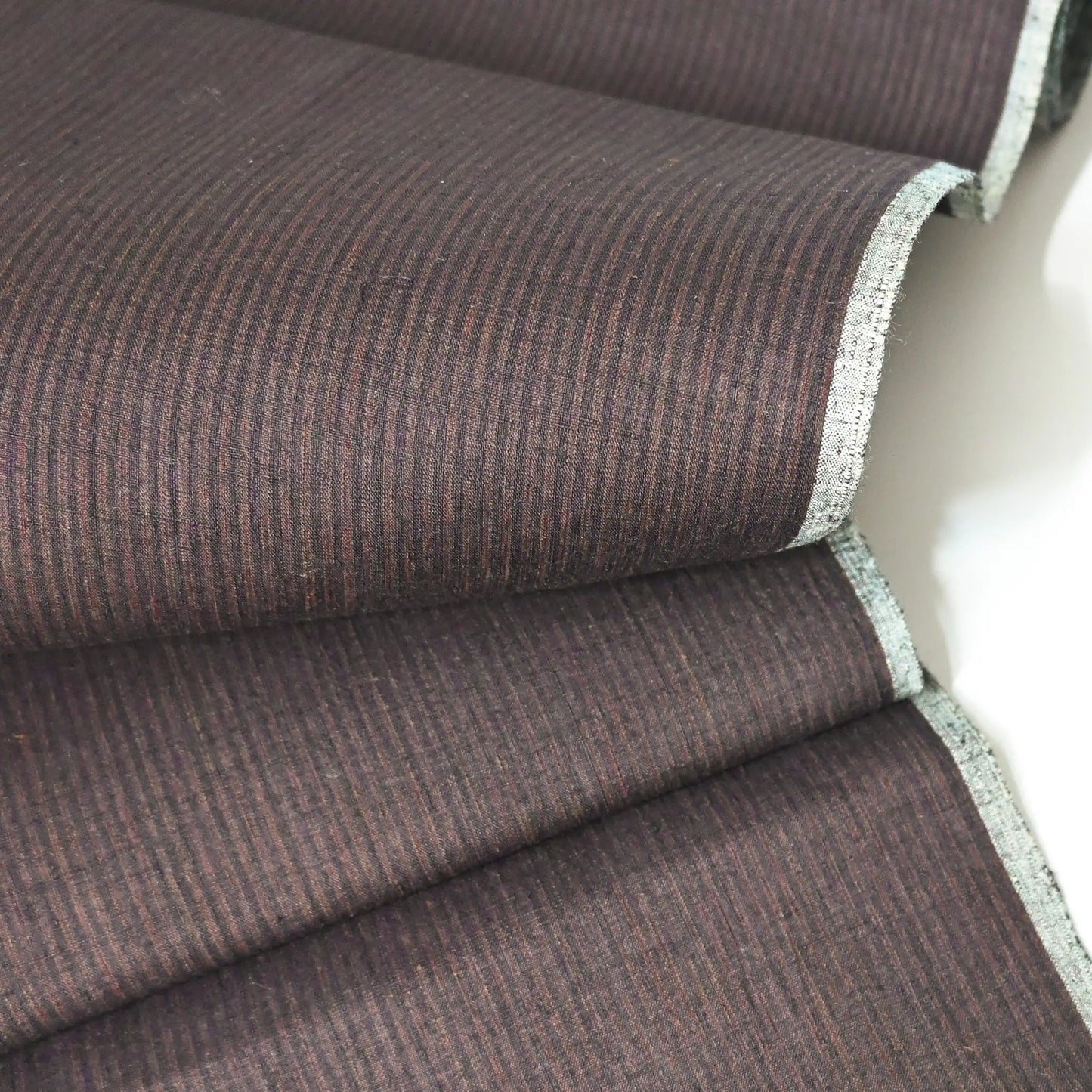 Detailed view of vintage silk kimono bolt with brown and navy fine stripe, sold by the metre.