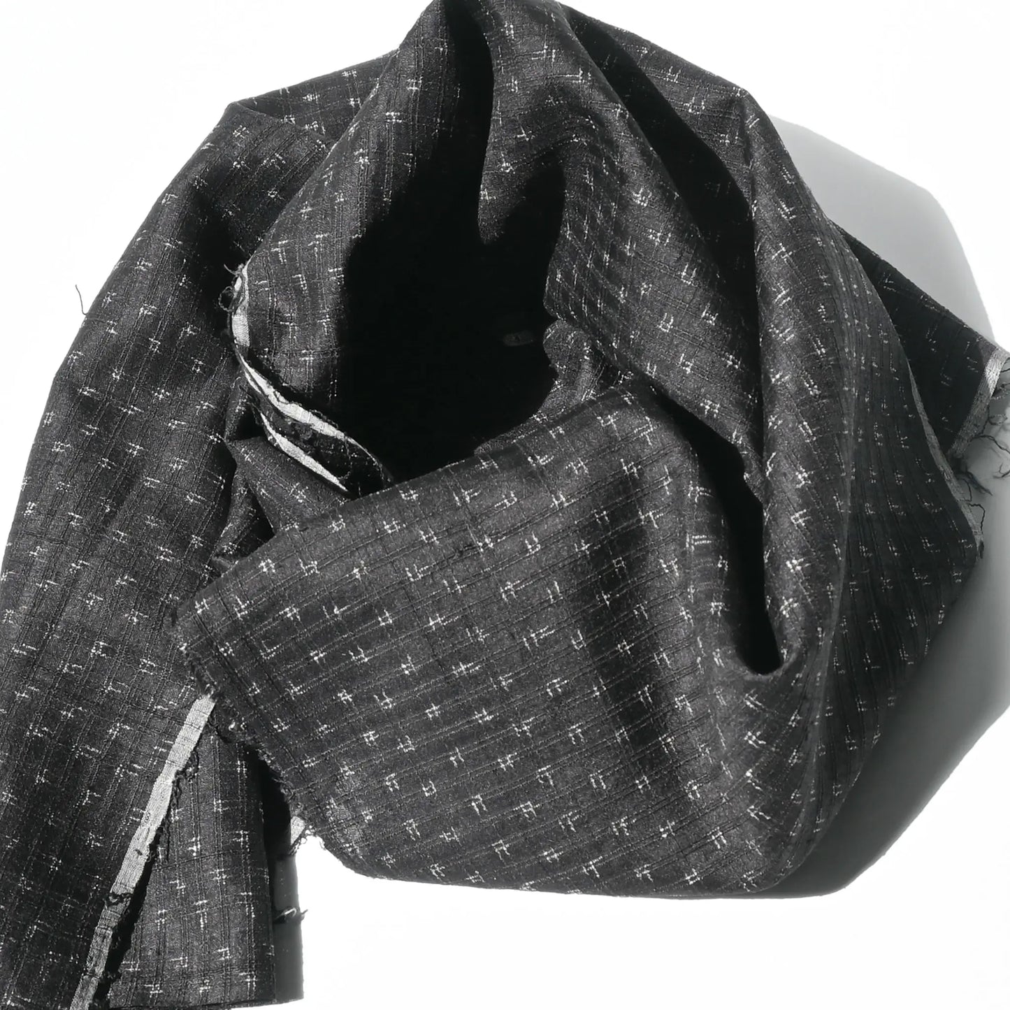 Detailed view of vintage silk kimono in dark navy with small kasuri woven pattern from the mid-20th century.