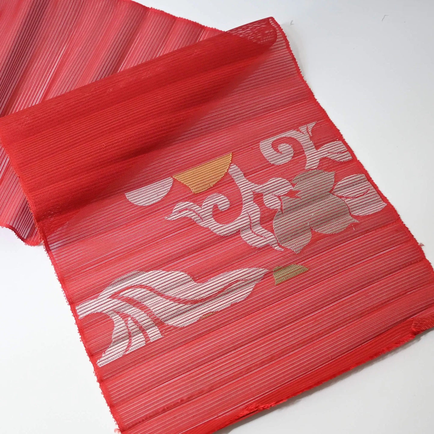 End of vintage Japanese red ro silk obi fabric, open weave.