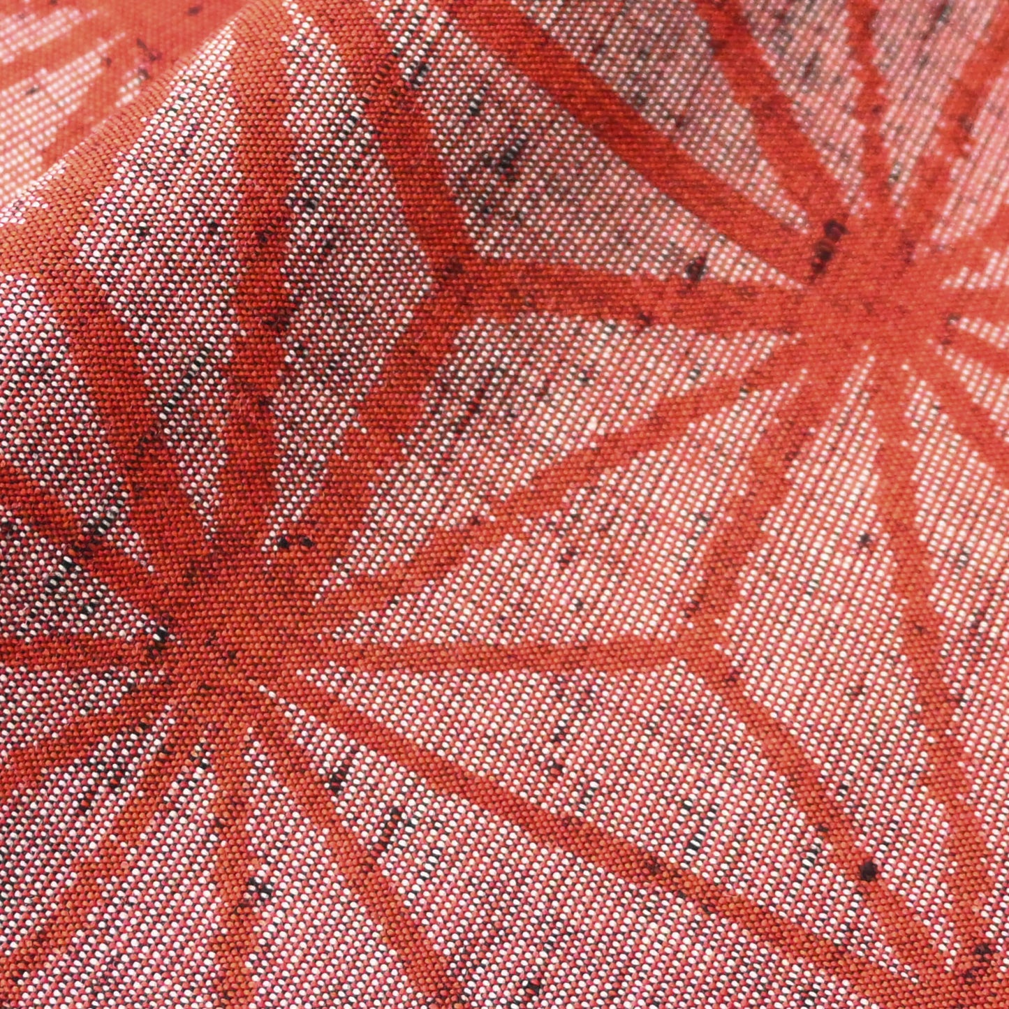 Close-up view of vintage wool kimono fabric in red with bold asanoha motif, sold by the metre.