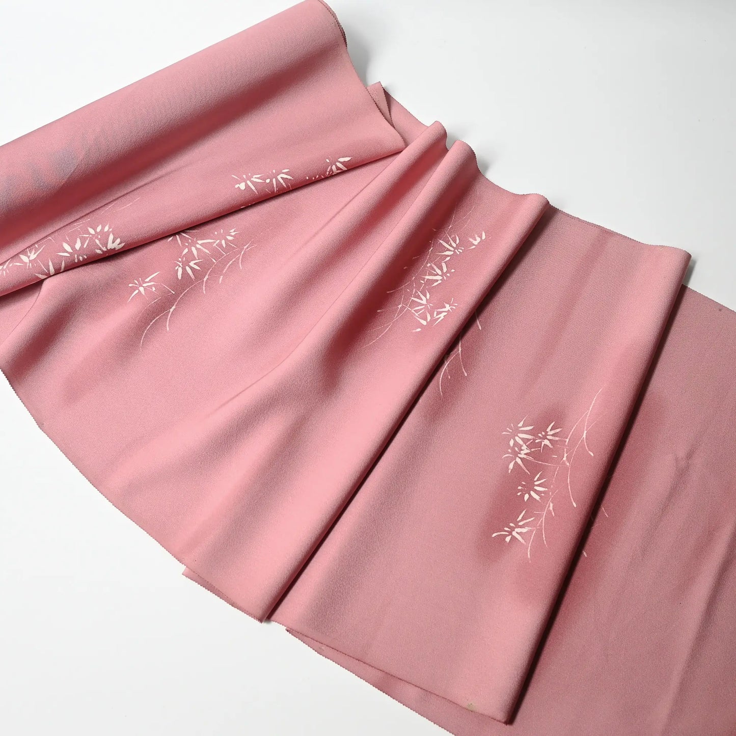 Full view of vintage Japanese silk kimono fabric in pale purple with a pink tone, featuring a bamboo motif.