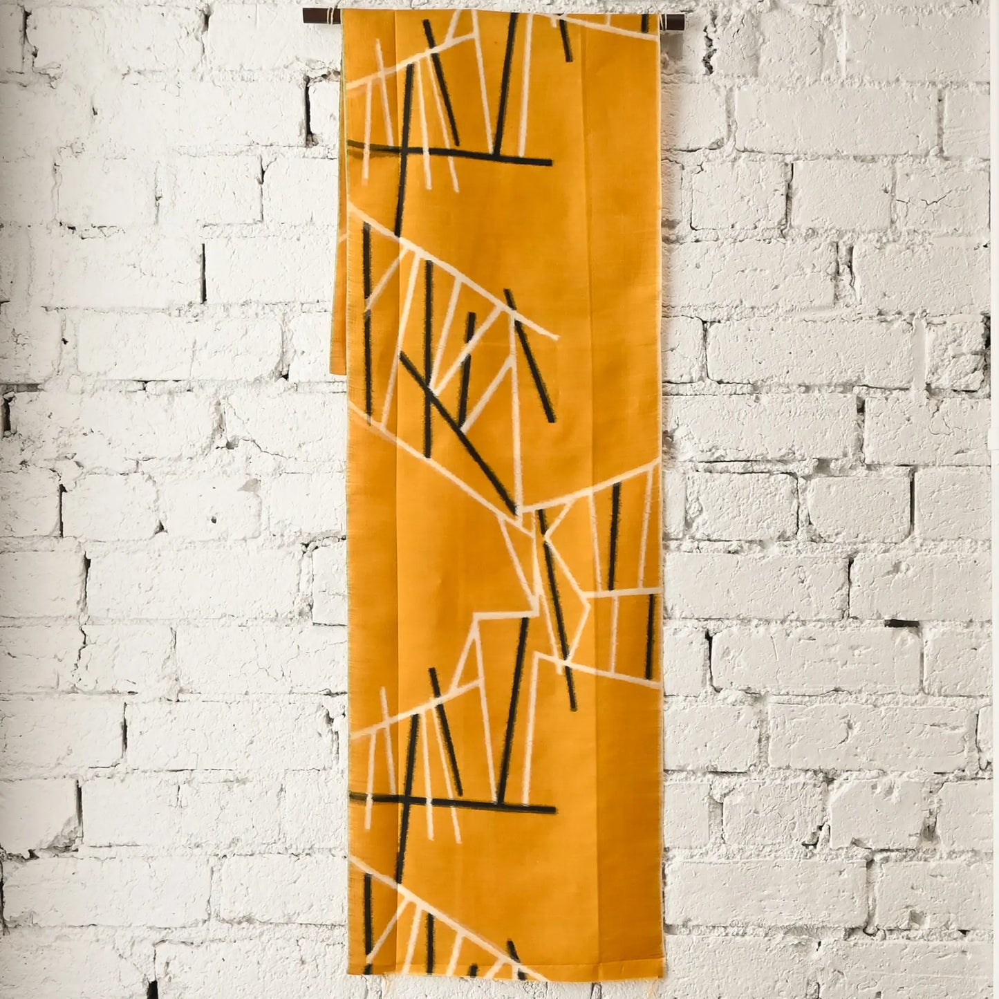 Full view of vintage Japanese Meisen kimono silk piece in striking yellow with black and white line motif from the mid-20th century.