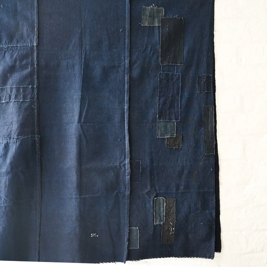 Detailed view of vintage Japanese three-panel plain indigo cotton futon cover with patches from the mid-20th century.