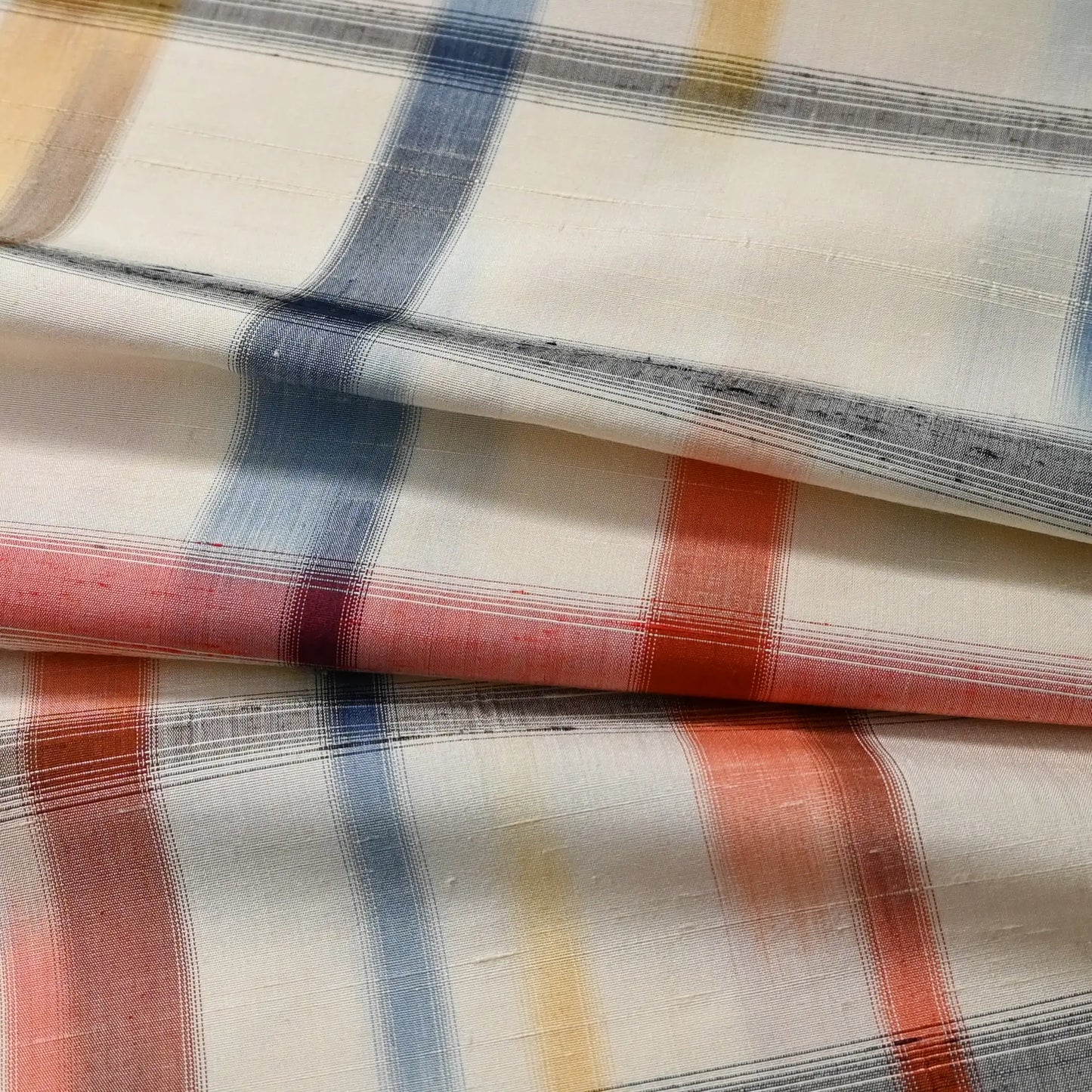 Detailed view of vintage Japanese white tsumugi silk with multi-coloured check kimono fabric.