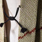 Close-up view of vintage women's silk shibori haori with an olive green and reddish-brown all-over pattern.