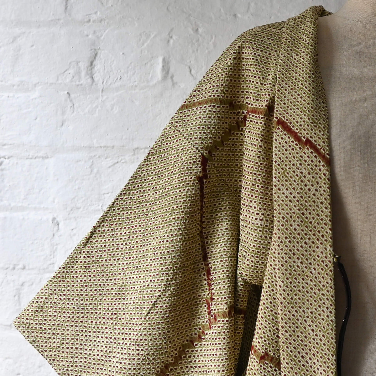 Vintage women's silk shibori haori with an olive green and reddish-brown all-over pattern.
