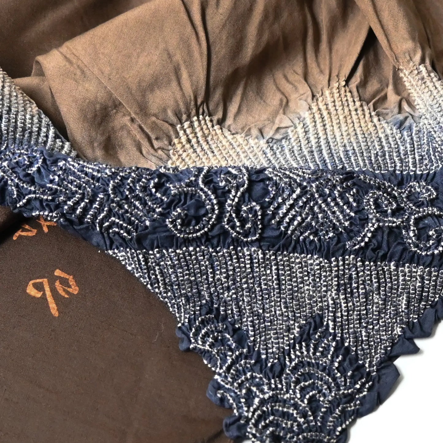 Close-up of vintage Japanese silk furoshiki with a hand-dyed shibori in brown.