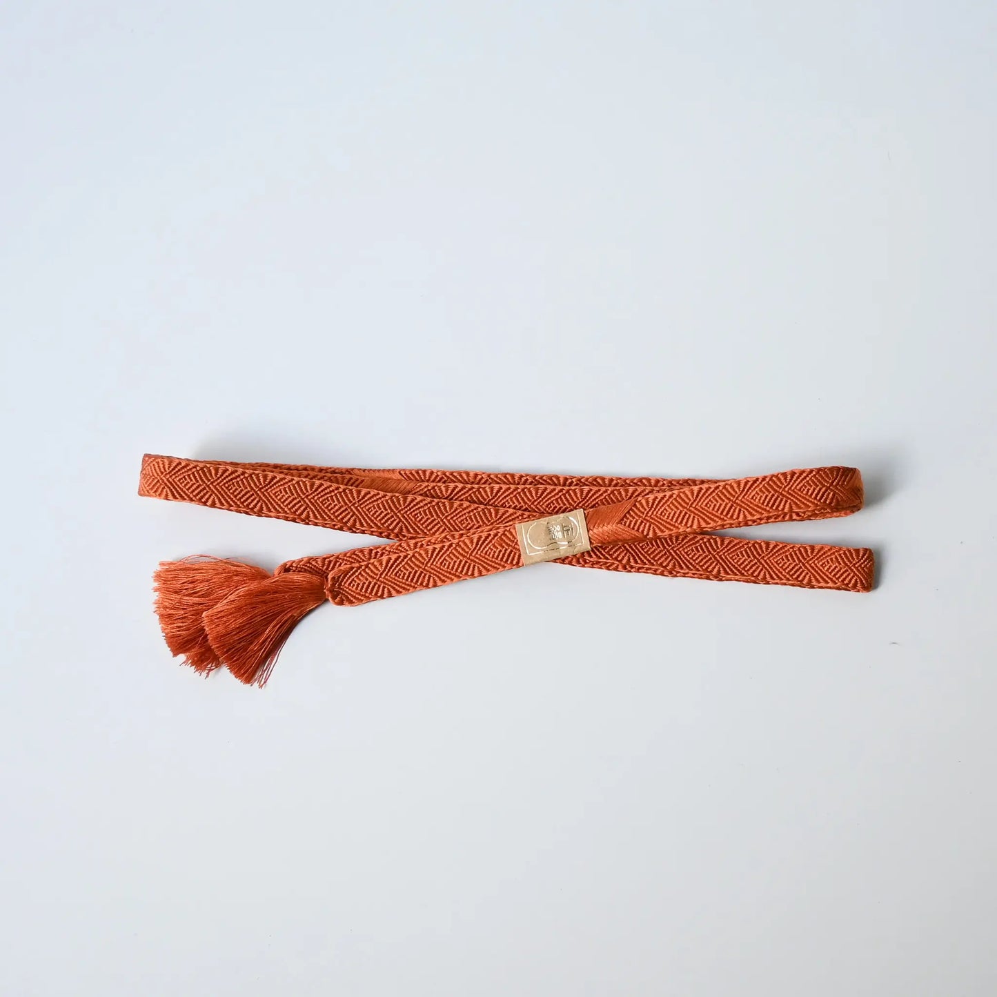 Recycled silk obijime braided cord in a beautiful burnt orange.
