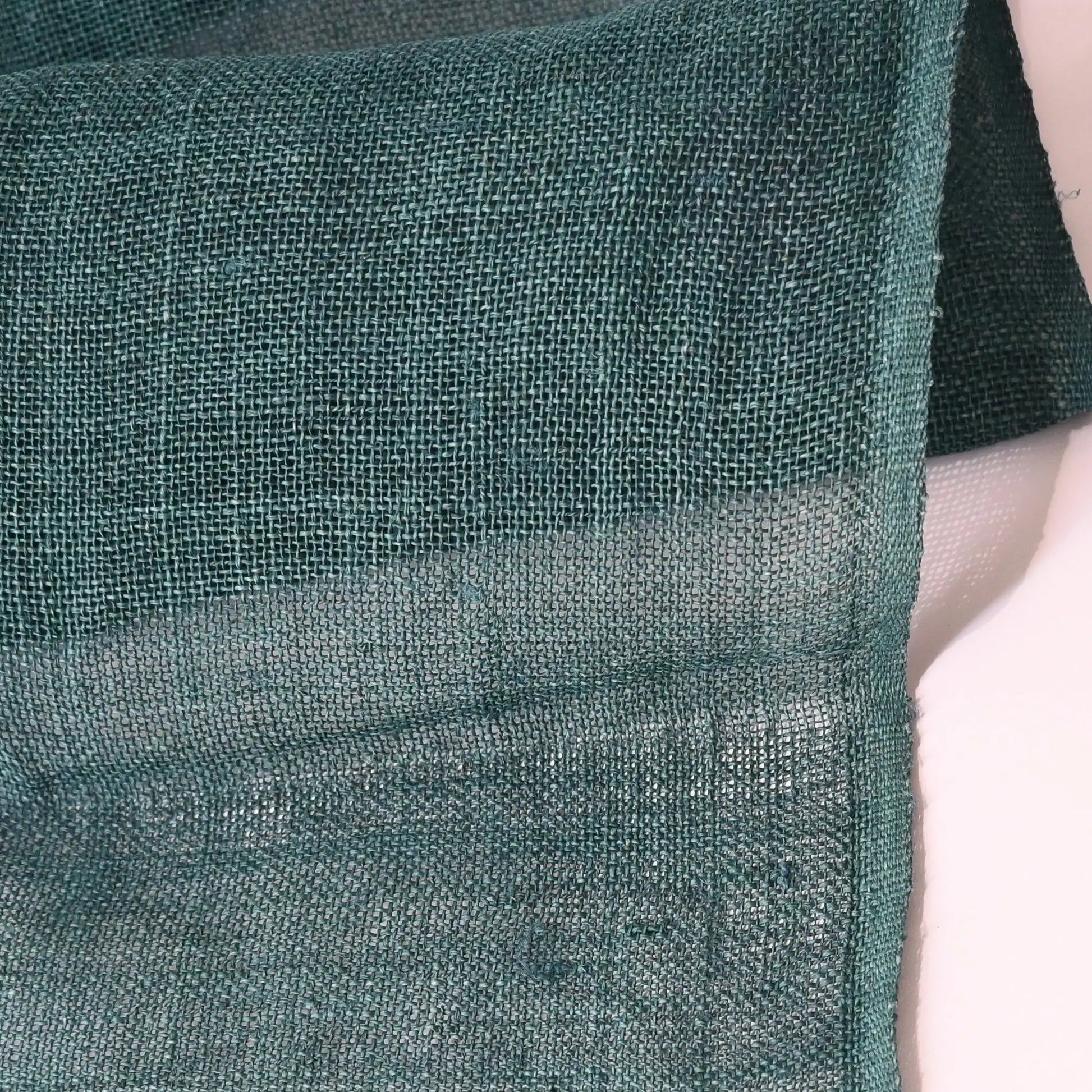 Close-up view of antique indigo green open weave hemp in indigo green, originally from a mosquito net Kaya.