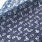 Close-up view of antique indigo Kasuri hemp with intricate floral pattern, originally an apron.