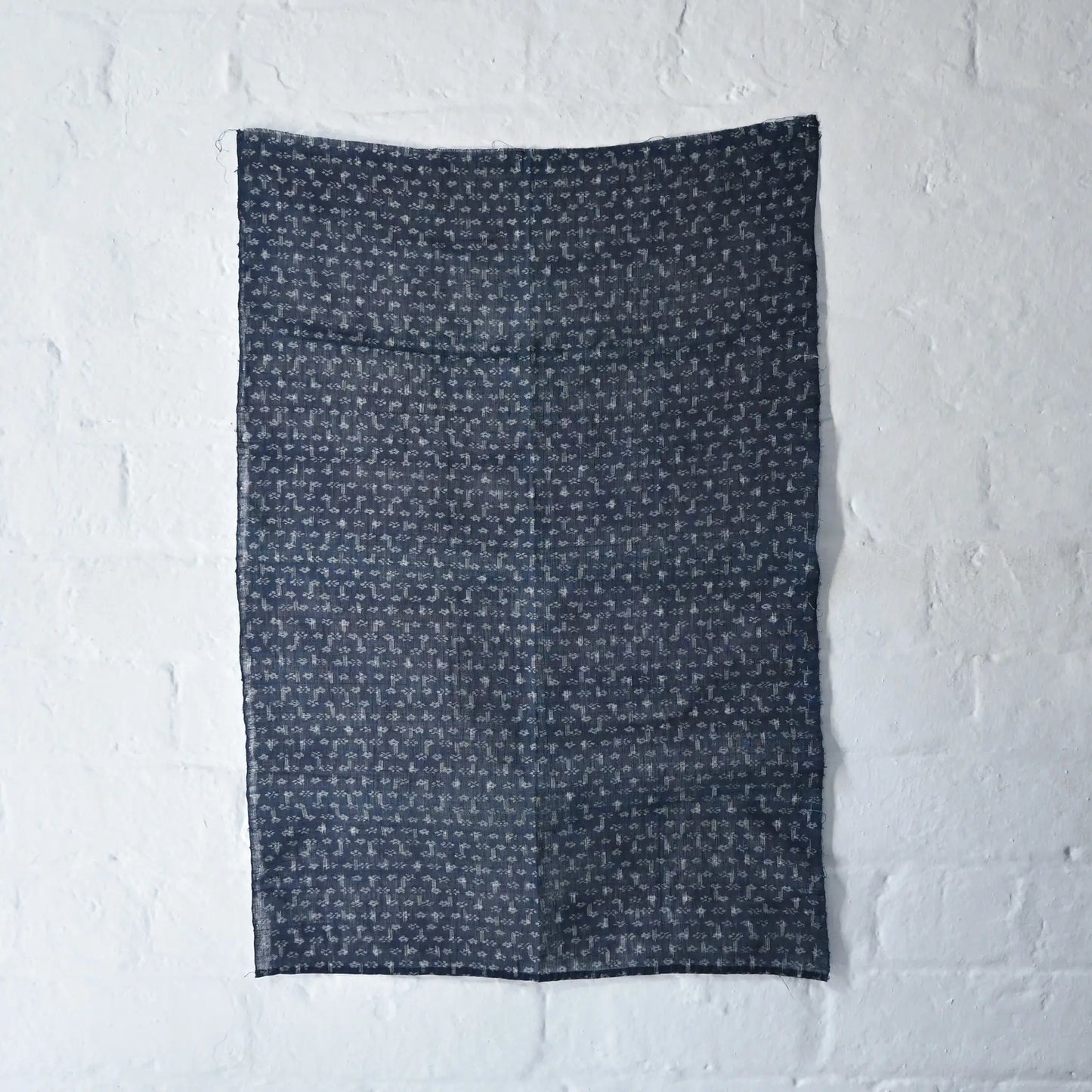 Full view of antique indigo Kasuri hemp with intricate floral pattern, originally an apron.