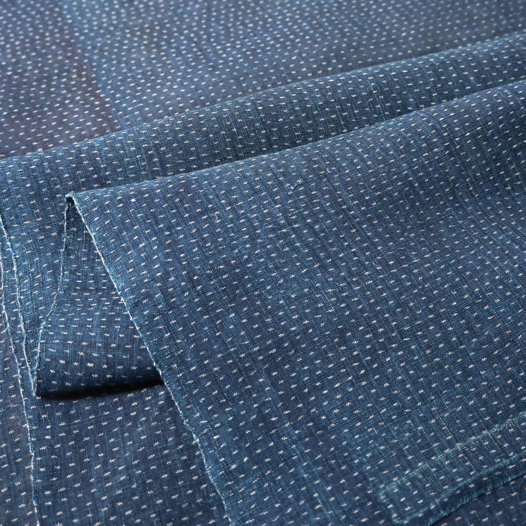 Close-up view of antique indigo kasuri hemp fabric piece from undone kimono, early 20th century.