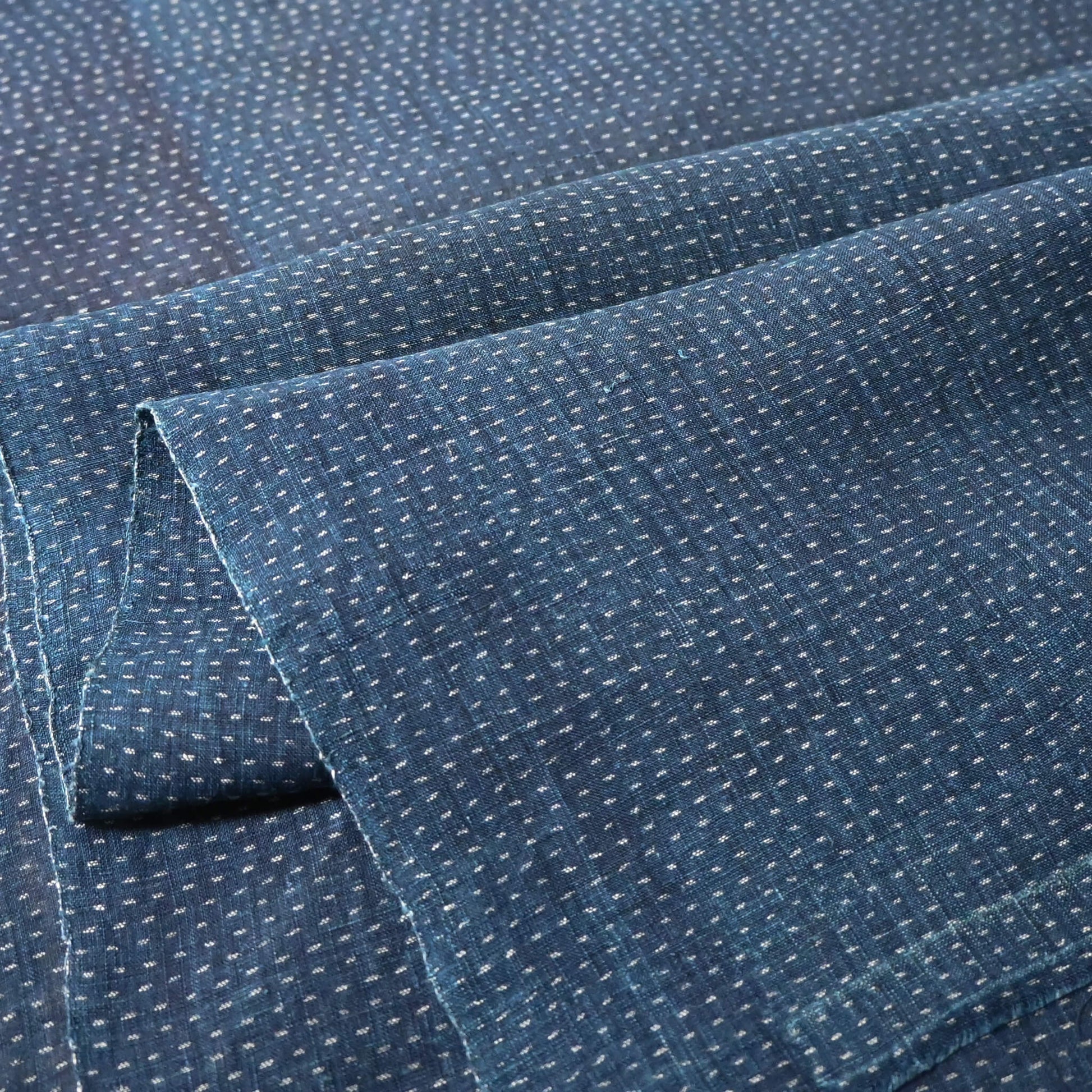 Close-up view of antique indigo kasuri hemp fabric piece from undone kimono, early 20th century.
