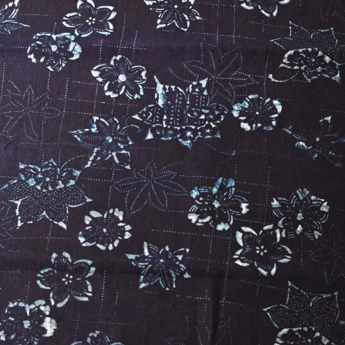 Close-up view of antique indigo katazome stencil dyed cotton with cherry blossom and maple leaf motifs, early 20th century.