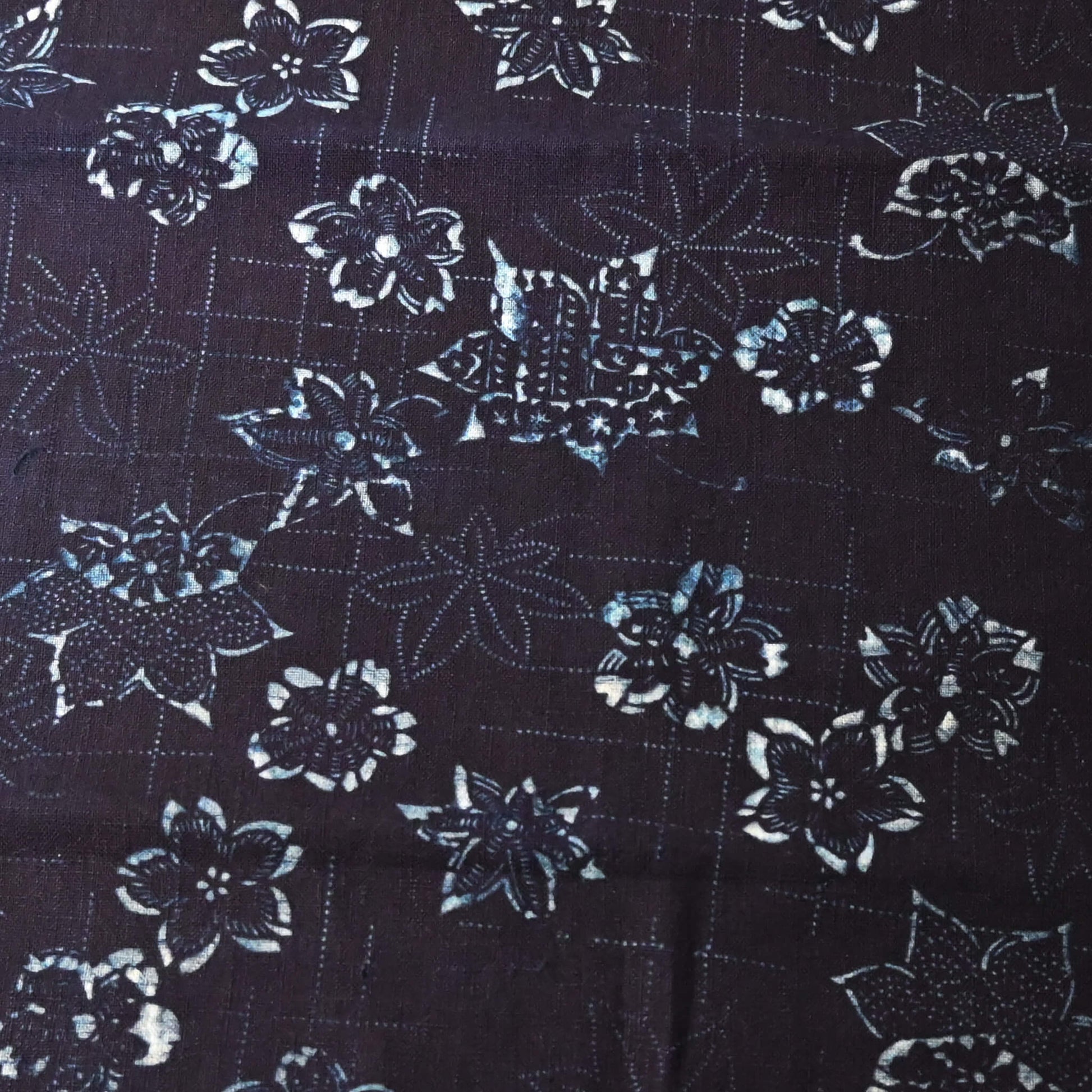 Close-up view of antique indigo katazome stencil dyed cotton with cherry blossom and maple leaf motifs, early 20th century.